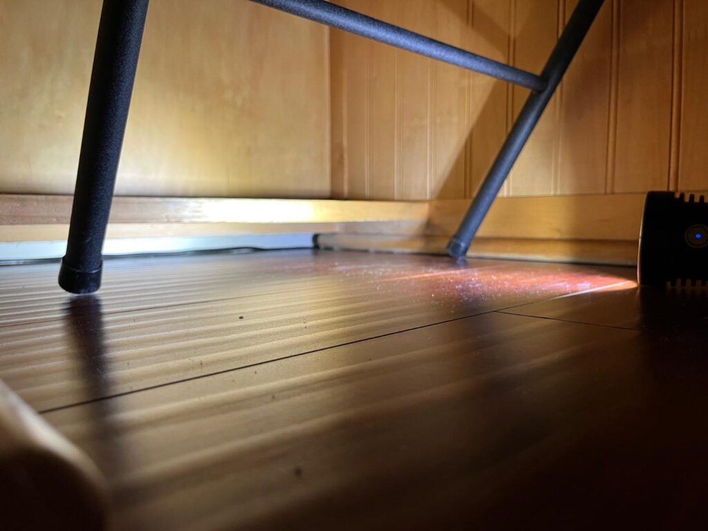 flash light shining underneath desk